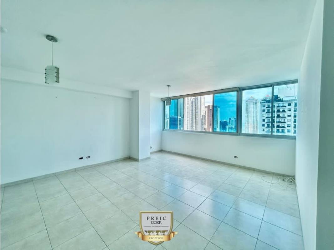 Living room with floor to ceiling windows offering expansive city and ocean views at Seawaves Panama