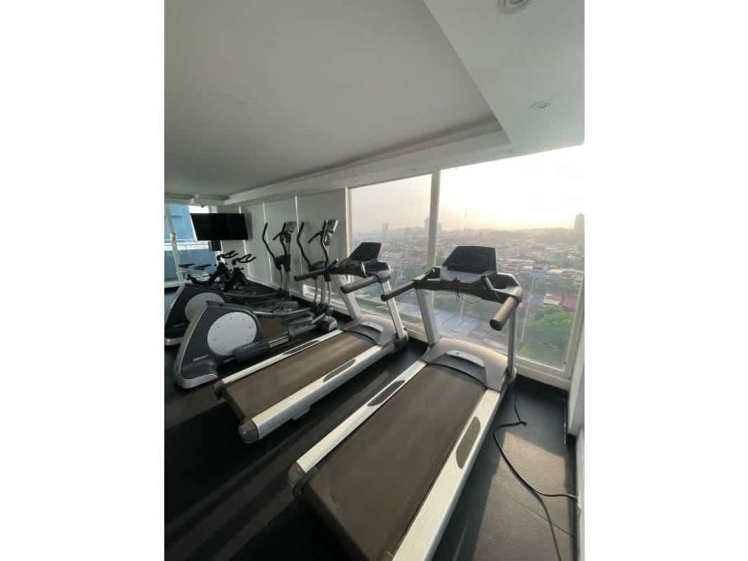 Living dining area with large windows, balcony access, city views at PH Cosmopolitan Towers