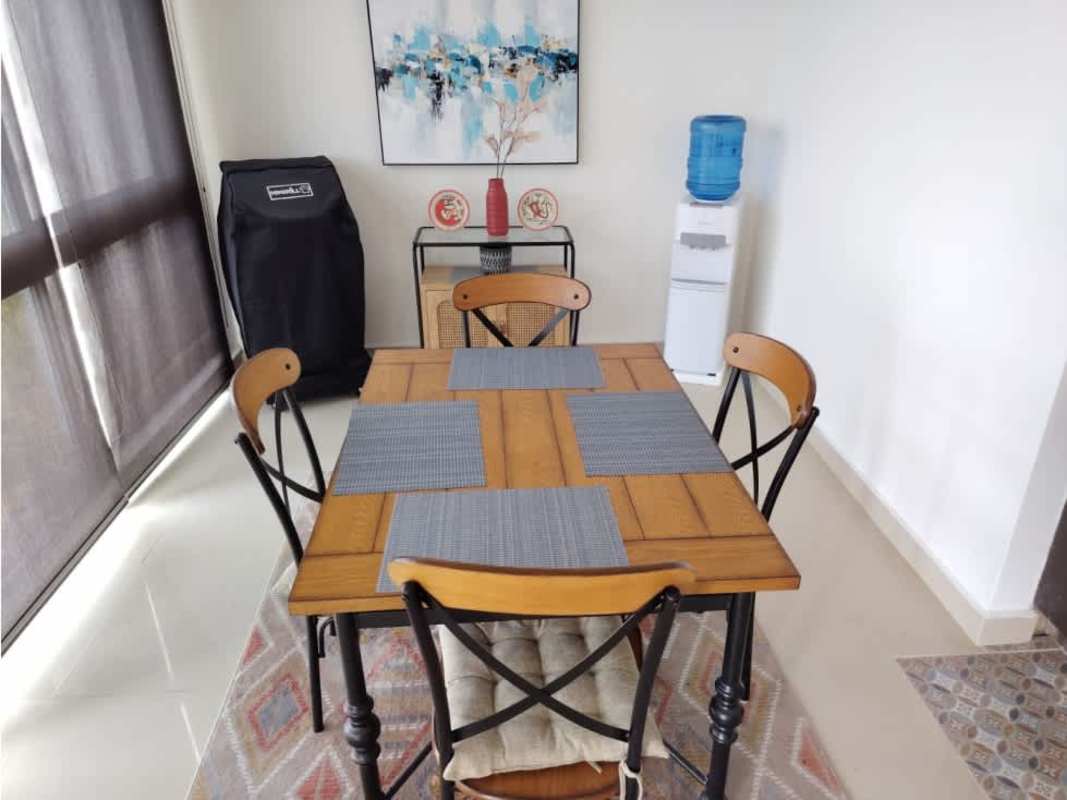 Dining space with wooden table, four chairs, large window in PH Pine Hill Clayton Panama