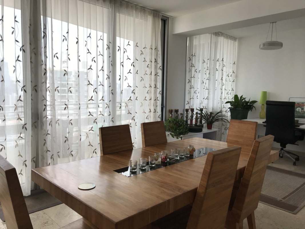 Bright dining area with large windows and city view at Junior Penthouse PH El Cangrejo Panama City