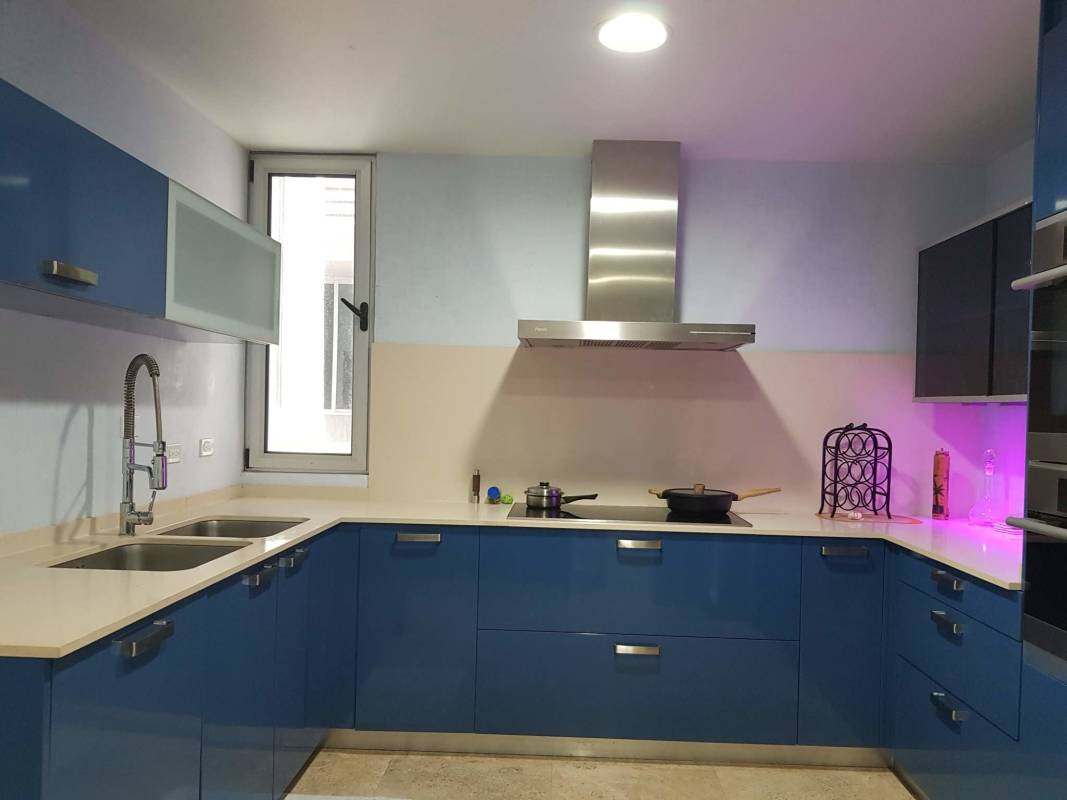 Fully equipped blue-tone kitchen with quartz countertops, modern appliances PH El Cangrejo Panama City