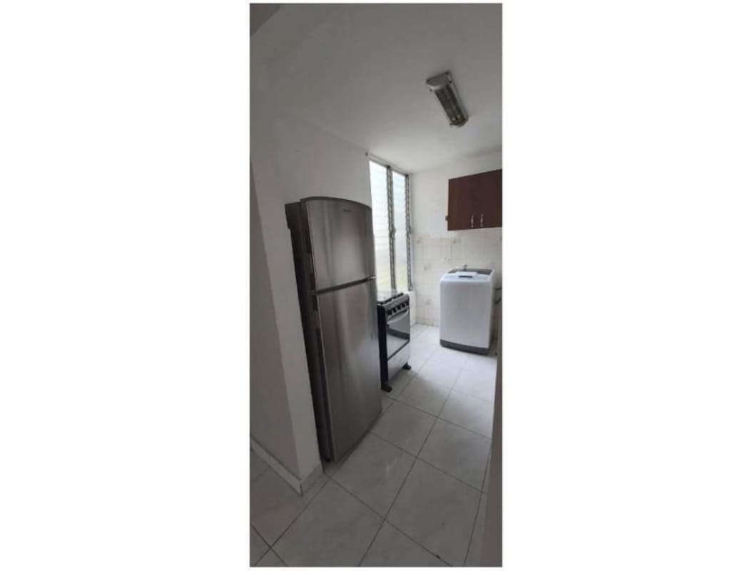 Compact kitchen with tiles, refrigerator, gas stove, and washer at PH Veracruz Carrasquilla Panama City