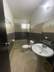 Contemporary bathroom glass enclosure pedestal sink tiled interior Villa Las Oropendolas Arraiján Panama