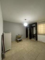 Minimalist bedroom gray walls built-in wardrobe dresser tiled floor rental house Panama