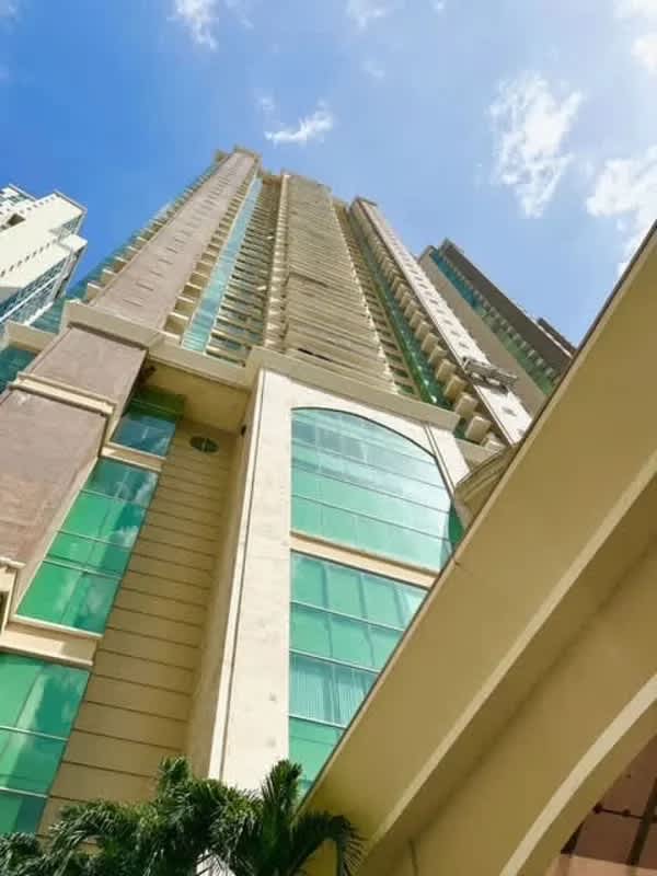 Tall beige and glass luxury towers with balconies Punta Pacifica Panama in PH Pacific Point complex