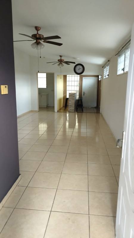Kitchen with tile backsplash, double sink, ceiling fan and cabinetry in house for sale Brisas del Golf Panama