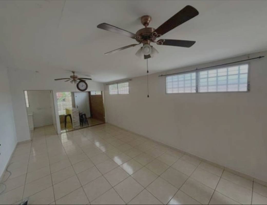 Open plan tiled living dining room with ceiling fans in house for sale Brisas del Golf Panama