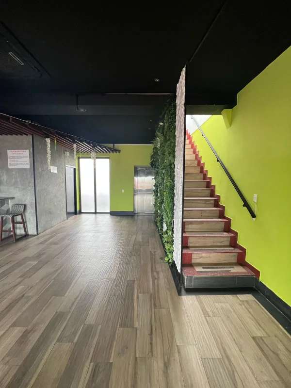 Industrial-style wine cellar with bottle racks, glass rail, exposed ceiling in Casco Viejo Panama