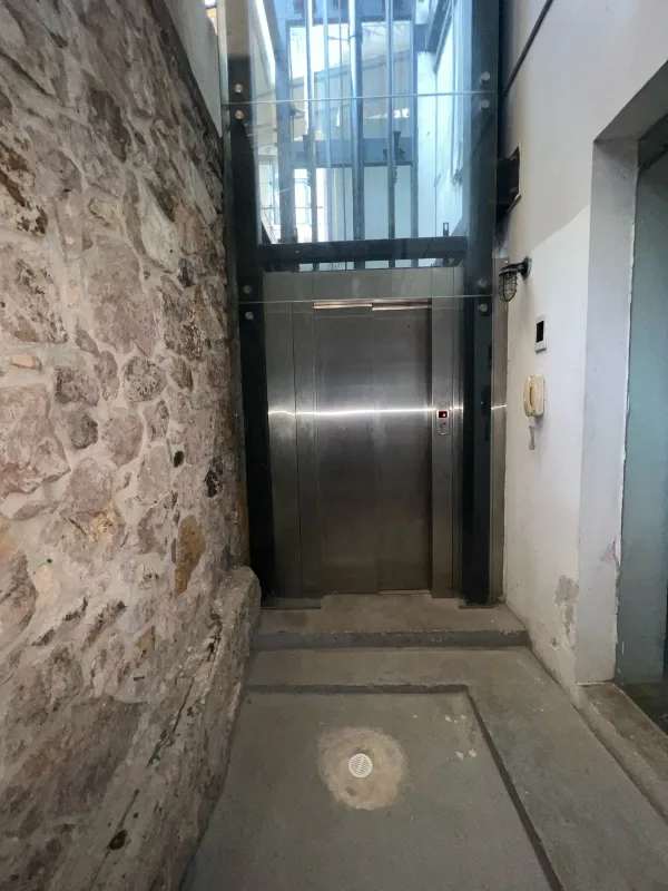 Eclectic lounge bar with wood floors, large windows, pendant lights in colonial Casco Viejo Panama