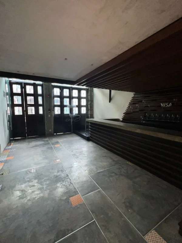 Reception with wood counter, geometric tile floor, large glass pane doors Casco Viejo Panama