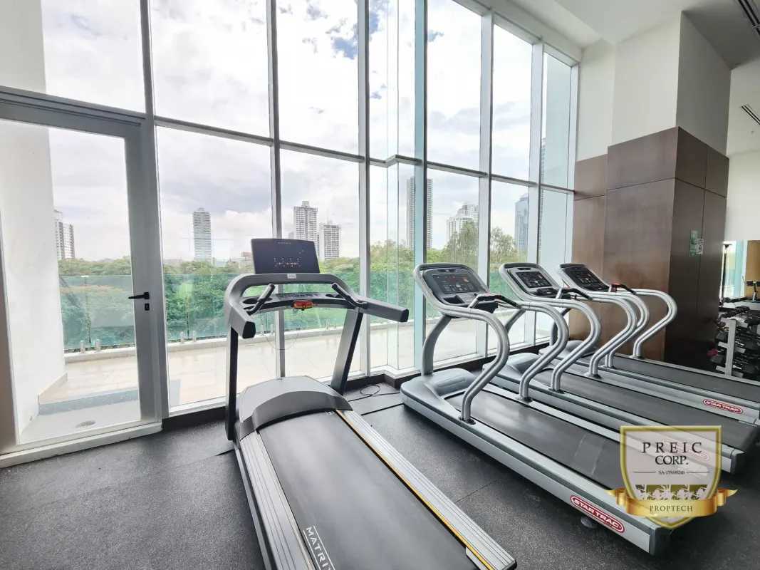 Infinity pool with sun deck and city skyline at PH Titanium Costa del Este Panama