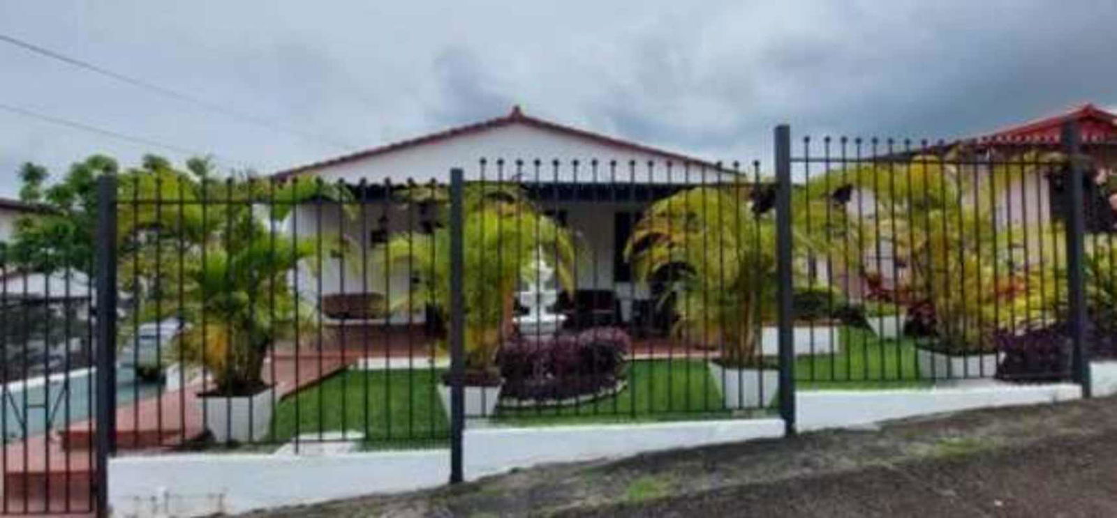 Kitchen with granite countertops, white cabinets and dining space Betania Panama