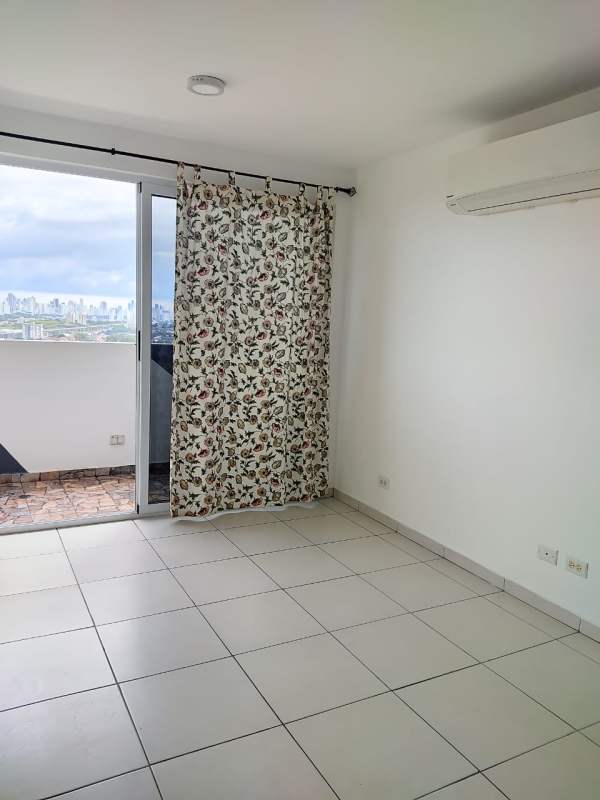 Living room with large glass door opening to balcony city Skyline at PH Mystic Valley El Crisol Panama