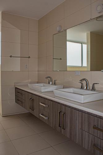 Double vanity marble bathroom with bathtub and walk-in shower at The Point Tower Punta Paitilla Panama