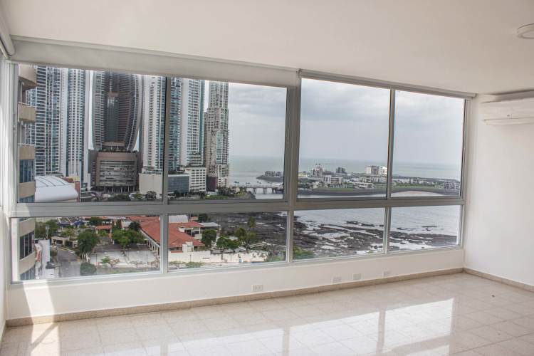 Master bedroom with marble floor and stunning floor-to-ceiling ocean views at The Point Tower Punta Paitilla