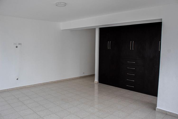 Luxury kitchen with granite countertops, appliances, and wood cabinetry at The Point Punta Paitilla Panama