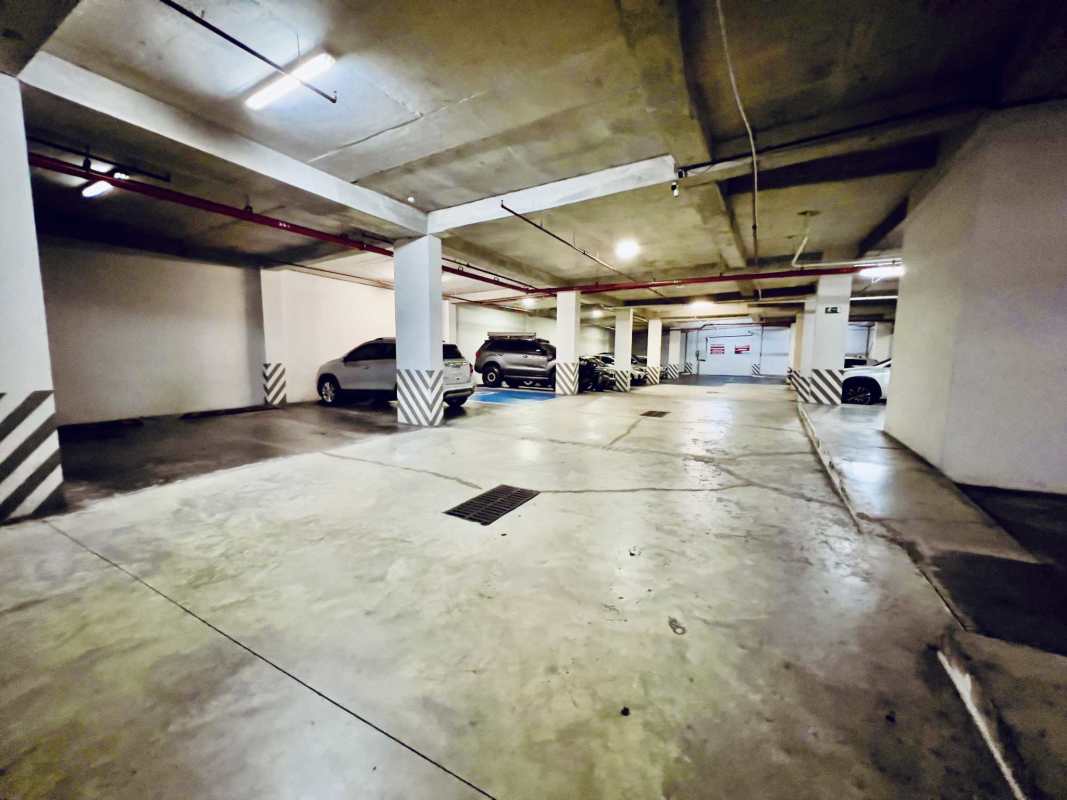 Entryway to parking area with security and commercial signage at San Francisco Plaza Panama