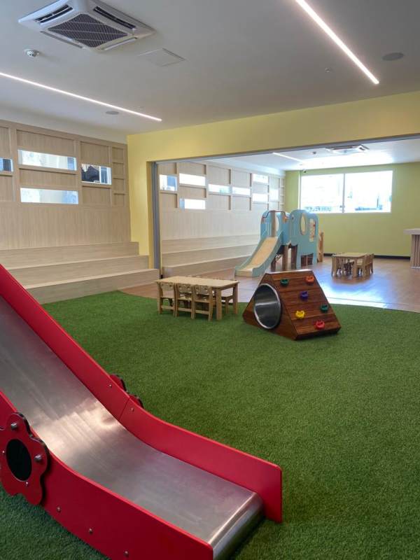 Modern children's playroom with playground equipment at PH Park City Panama
