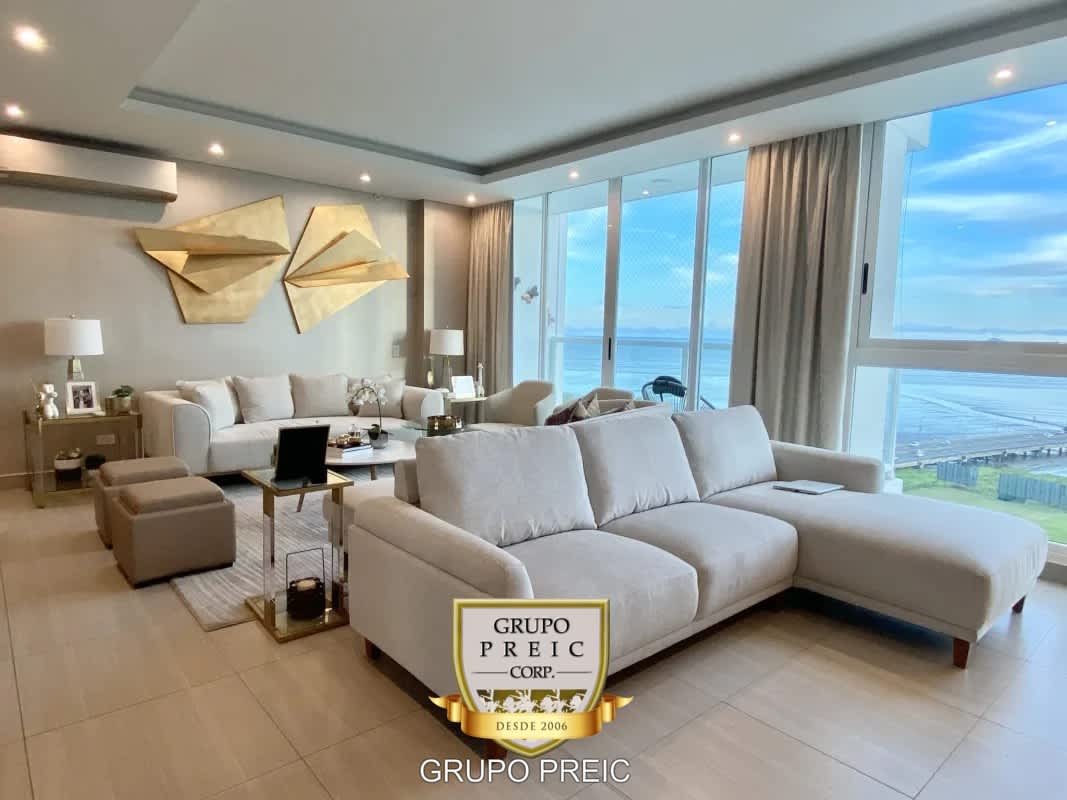 Living room with panoramic windows to ocean and skyline in PH Asia Costa del Este Panama
