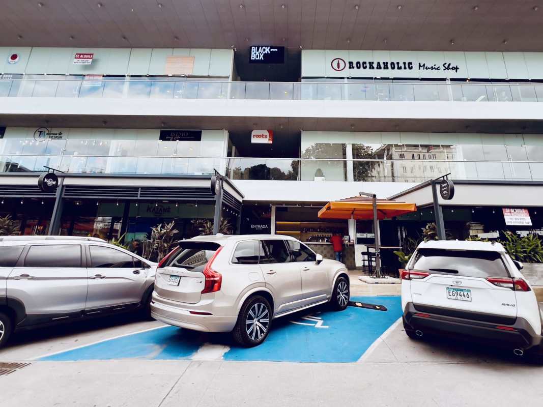 Street view of commercial plaza with glass windows and parking in San Francisco Panama