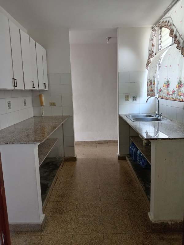 Kitchen with granite countertops, white cabinets, tiled backsplash in PH Santa Elena Chanis Panama