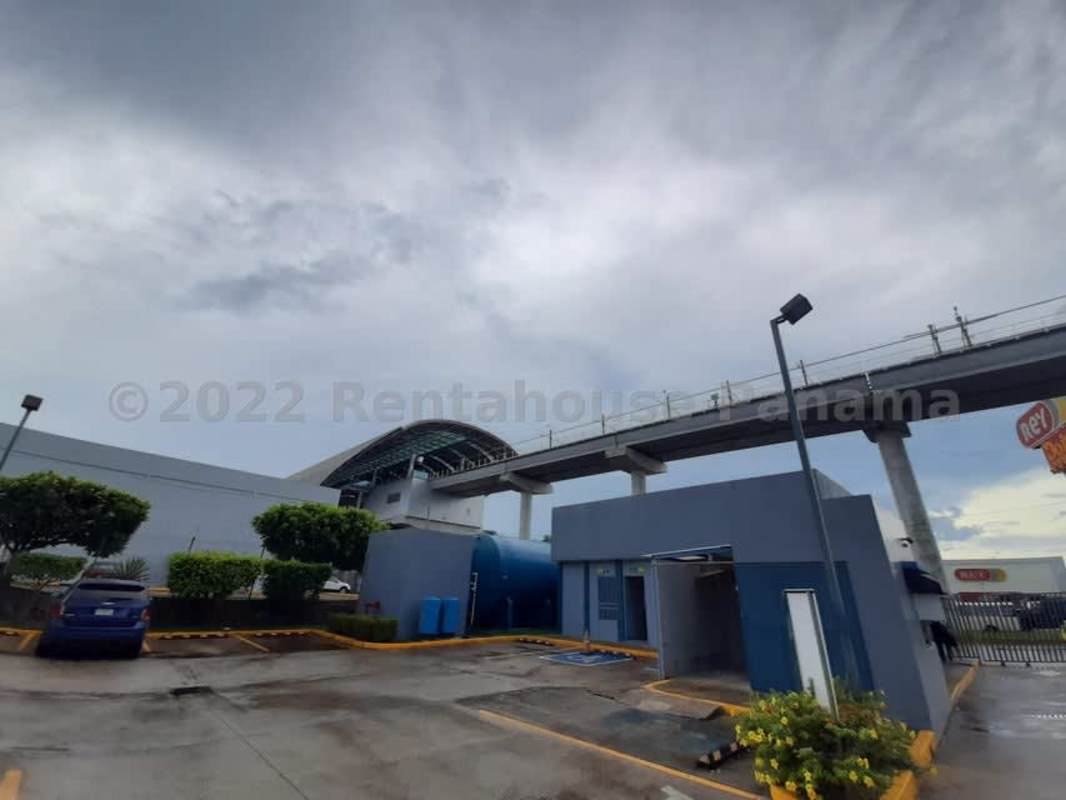 Modern commercial warehouse entrance with glass doors, rolling security shutter and signage in Tocumen Panama