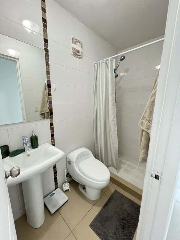 Secondary furnished bedroom with large window and closet in PH Teus Tower Carrasquilla Panama City