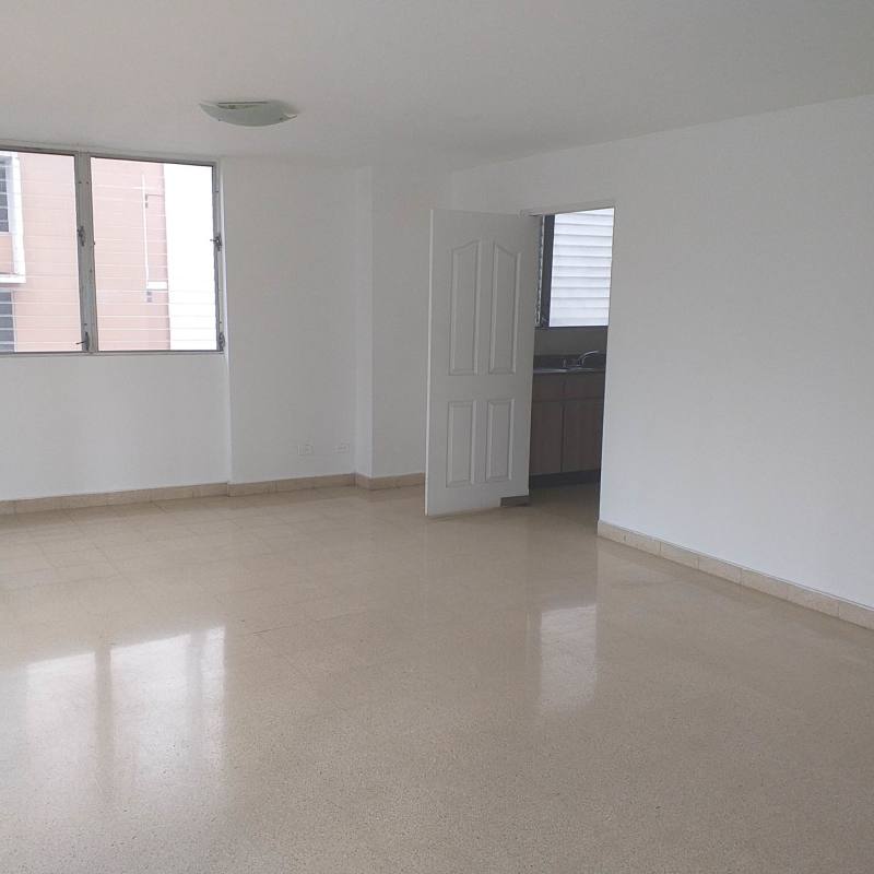 Bright living room with big windows, tiled floor, connected to dining and kitchen in PH Vista Mar Obarrio