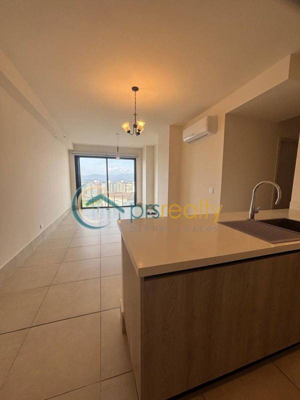 Spacious living dining area with large windows and balcony access in PH Ocean House Santa María