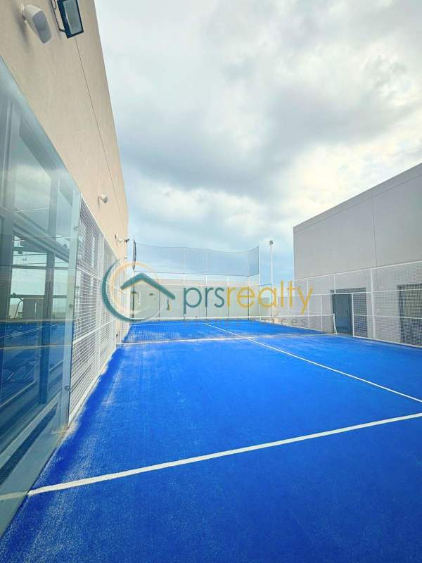 Open kitchen with island and appliances inside apartment PH Ocean House