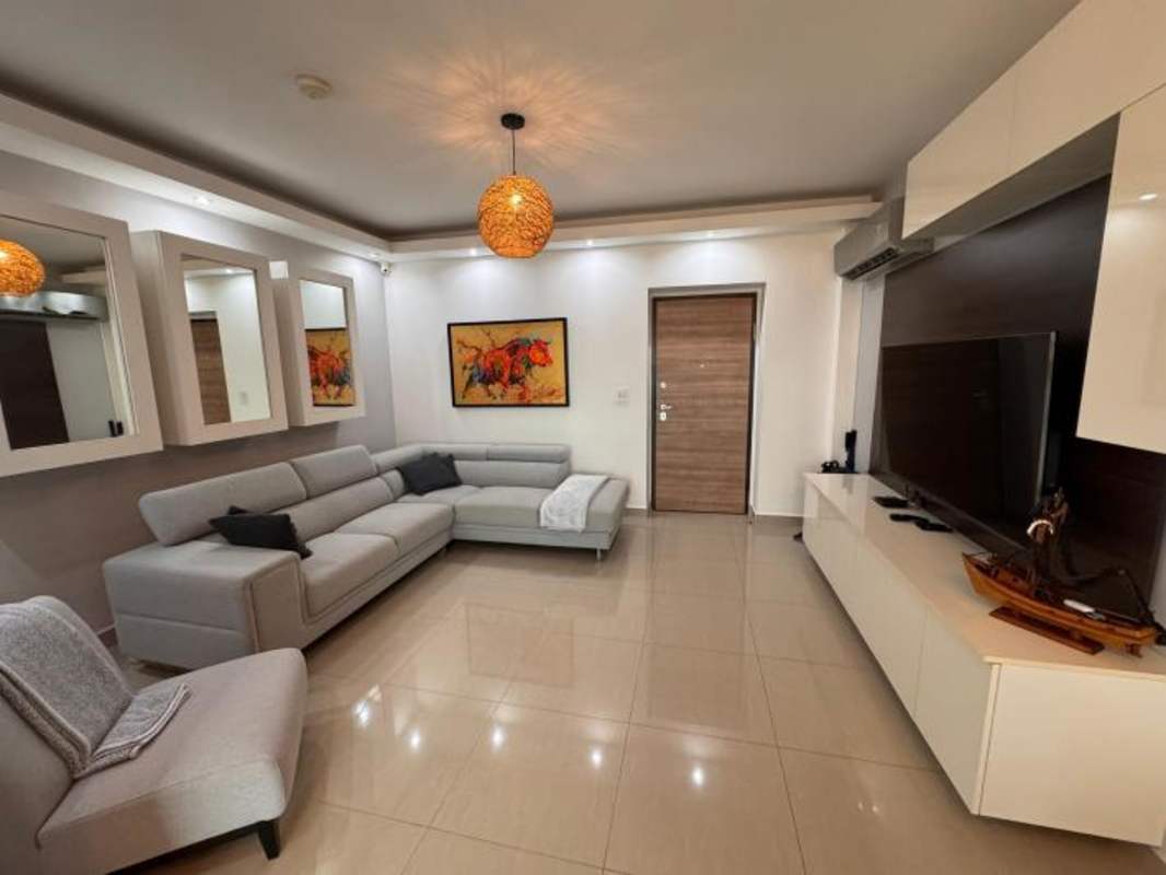 Contemporary furnished living and dining area with sofa and dining set in PH Venezia Tower El Carmen