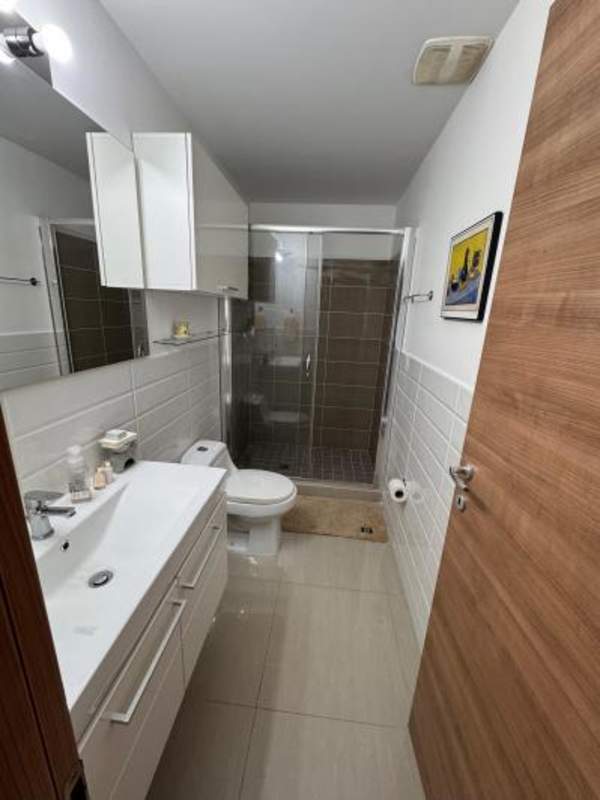 Modern bathroom with glass enclosed shower and vanity in PH Venezia Tower Panama City