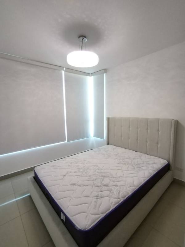Minimalist bedroom with upholstered bed, tile flooring in Top Tower Costa del Este Panama