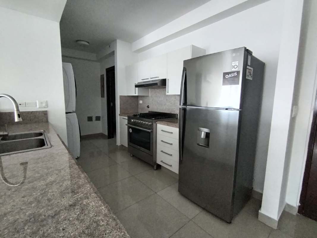 Modern kitchen with stainless appliances, granite counters, white cabinets in Top Tower Costa del Este