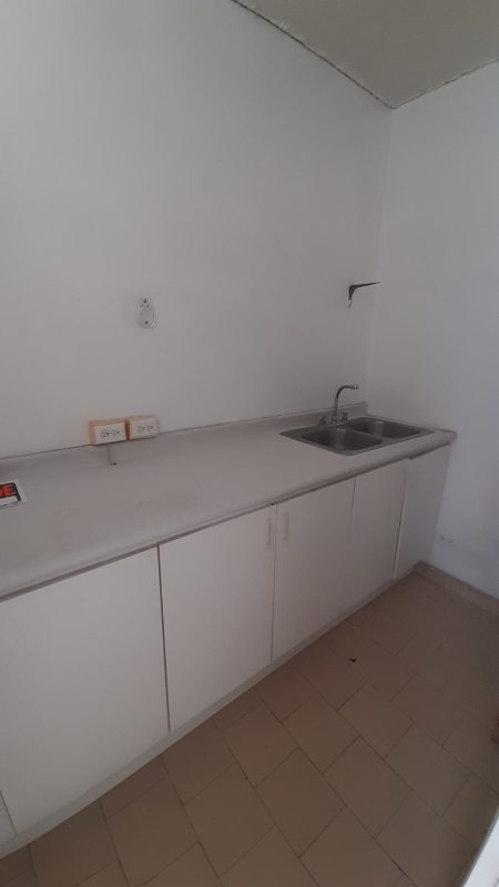 Minimalist kitchenette with double sink, white cabinets in PH Clínicas El Dorado Panama
