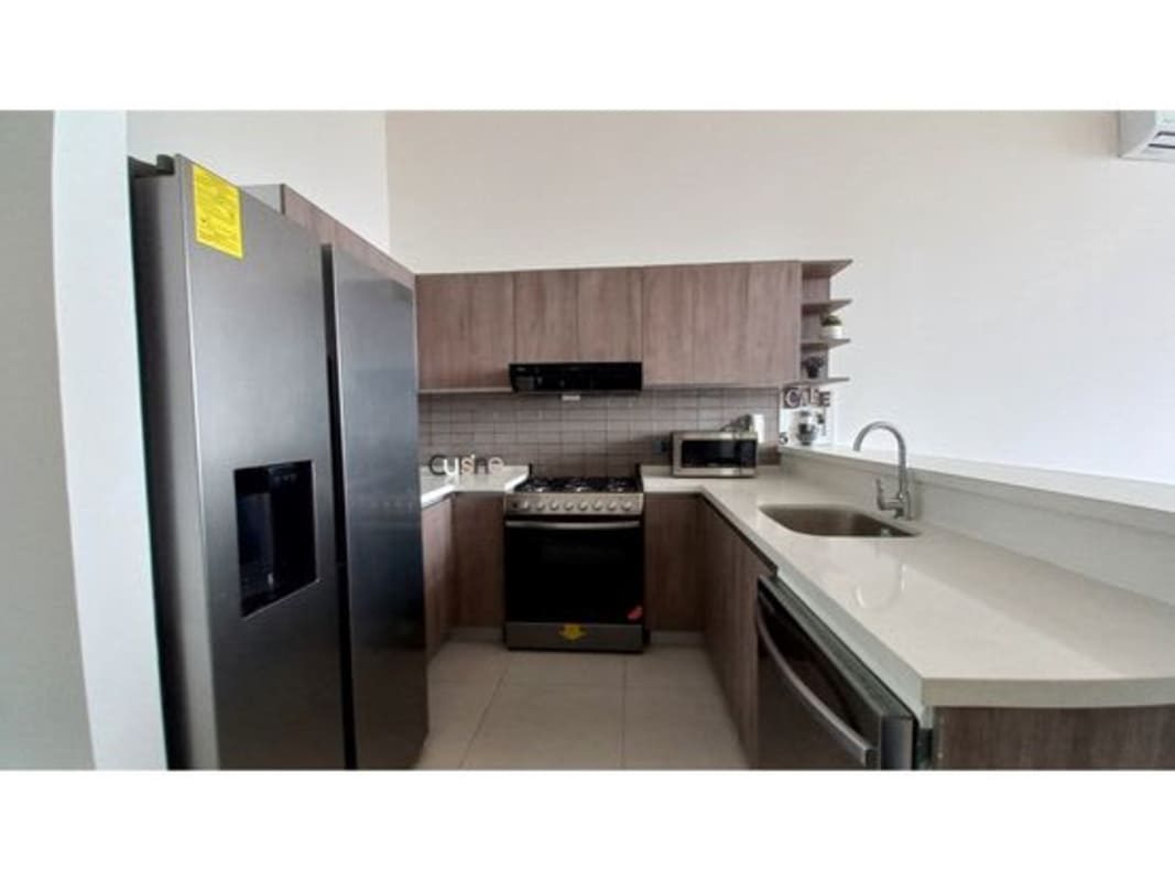 Contemporary kitchen with stainless appliances, tile backsplash, open layout at PH Coco del Mar Panama