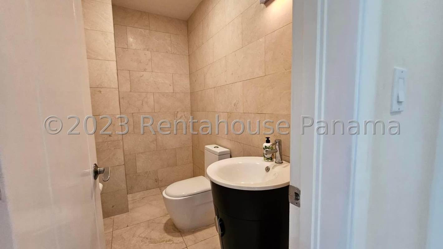 Spacious master bedroom with large windows blue accent wall AC marble floors overlooking the ocean in Casa Bonita Playa Bonita Panama