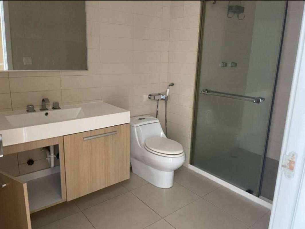 Minimalist bathroom with glass-enclosed shower and vanity in PH White Tower Panama City