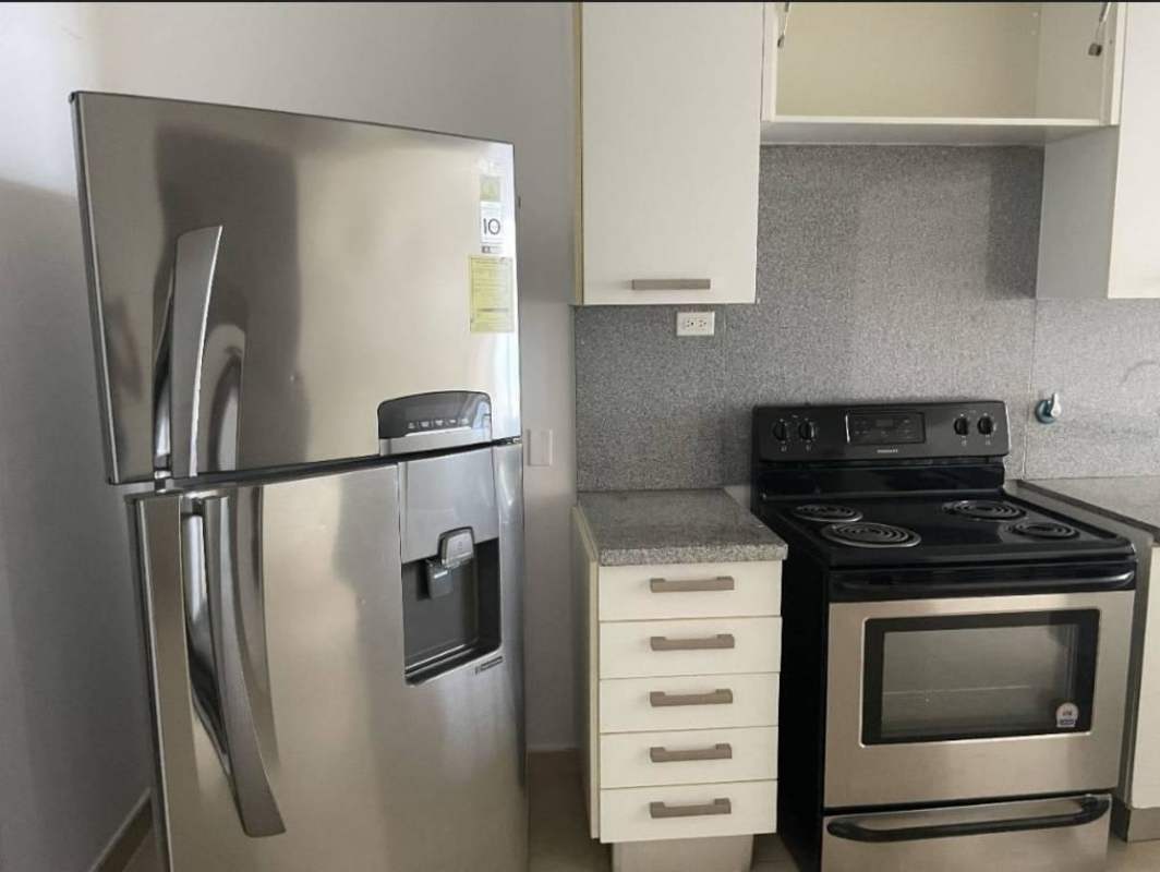 Modern kitchen area opening into hallway in PH White Tower apartment Panama City