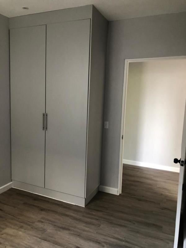 Bathroom with marble-style tiles, vessel sink, gray vanity, remodeled rental Obarrio Panama City