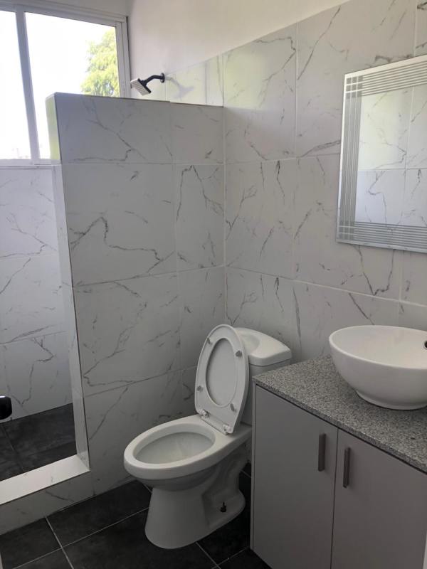 Bathroom with marble-look tiles, vessel sink, walk-in shower, modern vanity Obarrio Panama