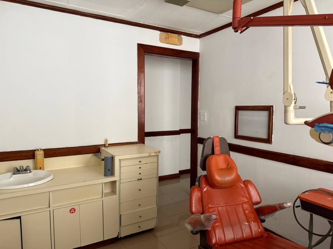 Reception area with wooden counter and built-in shelves commercial office space PH Santa Fe El Carmen Panama