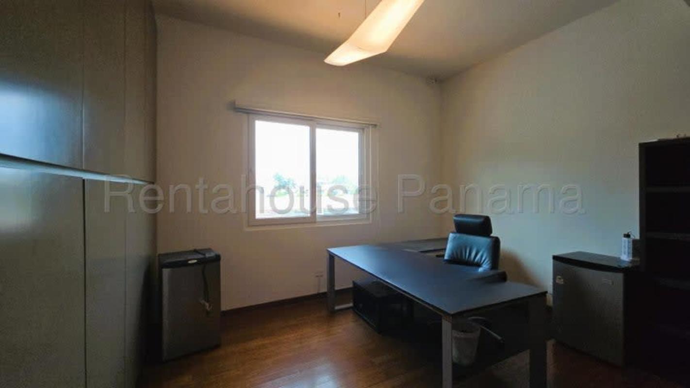 Luxury kitchen with center island, stainless appliances and wood cabinets in Costa del Este house Panama