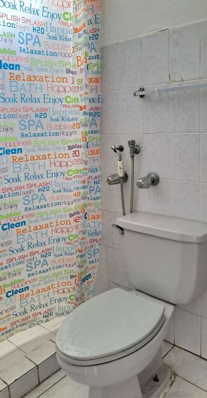 Functional bathroom with white tile walls, shower, toilet PH Torres del Sol Hato Pintado Panama