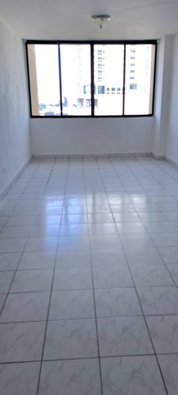 Living room with ceramic tile flooring and large window in PH Torres del Sol Hato Pintado Panama
