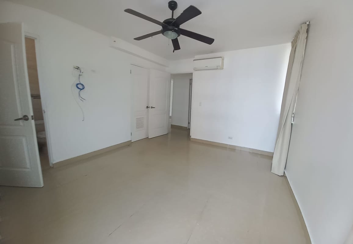 Bedroom with ceramic tile flooring, split AC, ceiling fan, and closet PH San Francisco Bay Panama City