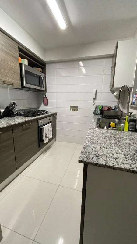 Living room with large windows, balcony access, ceiling fan in PH Mid Park Panama City