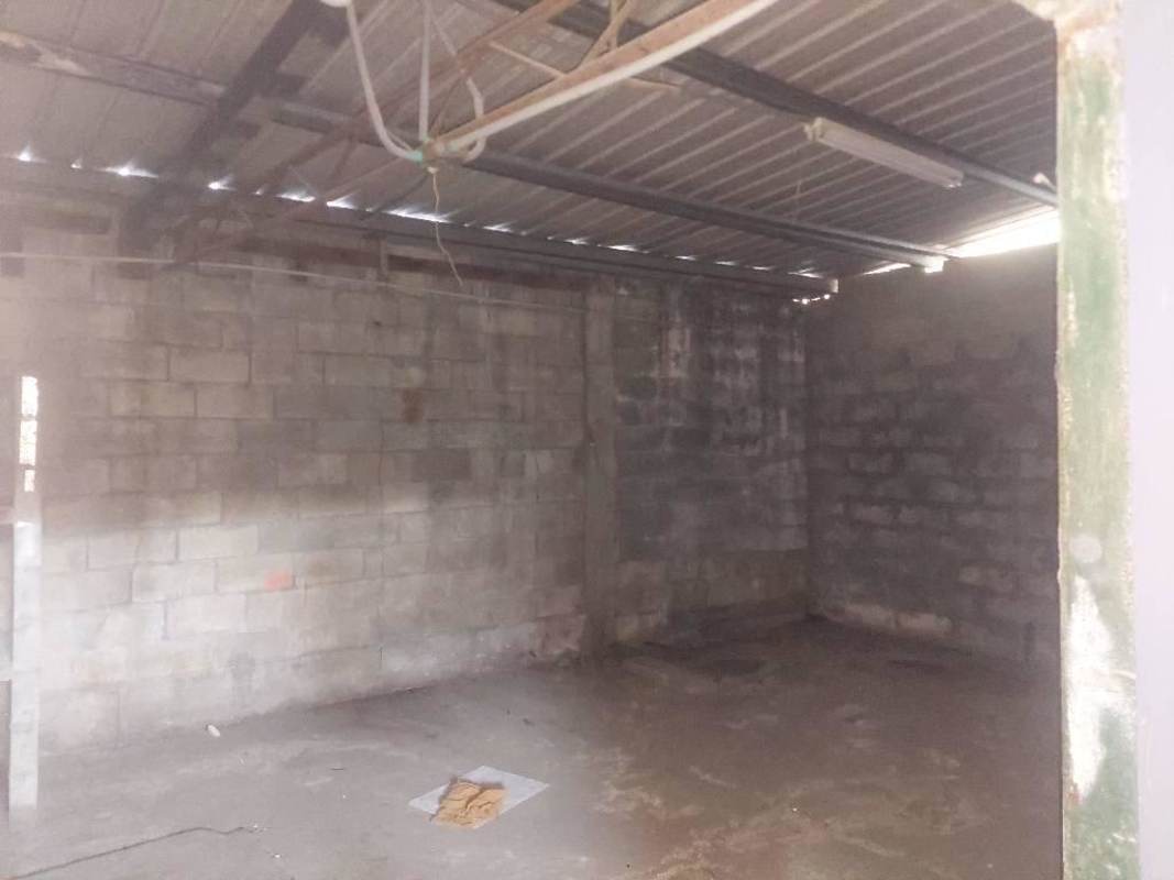 Empty storage room with concrete walls and metal roofing inside industrial warehouse Parque Lefevre Panama City