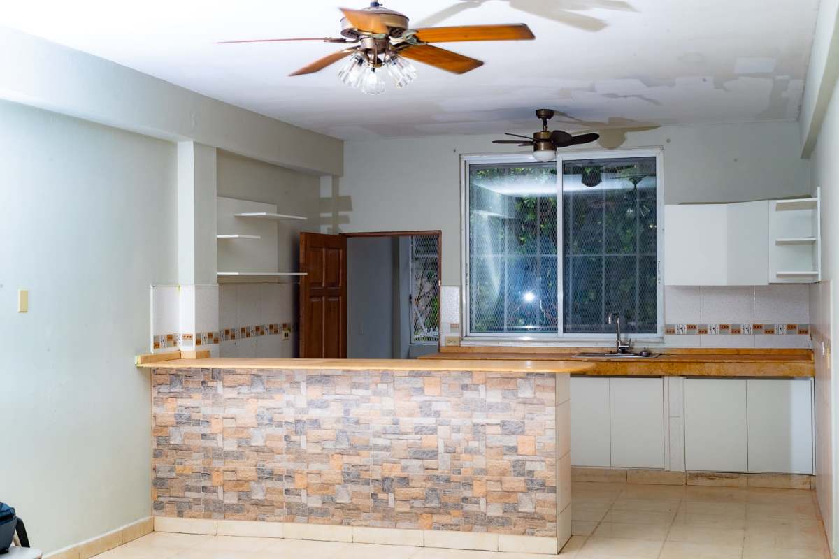 Entryway with wooden door, security gate and decorative mirrors in Panama apartment