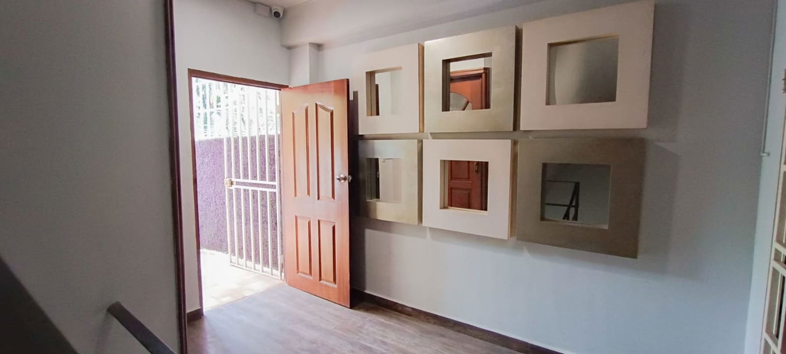 Open plan living area with tiled floors, ceiling fans, kitchen bar and bright interior in San Francisco Panama